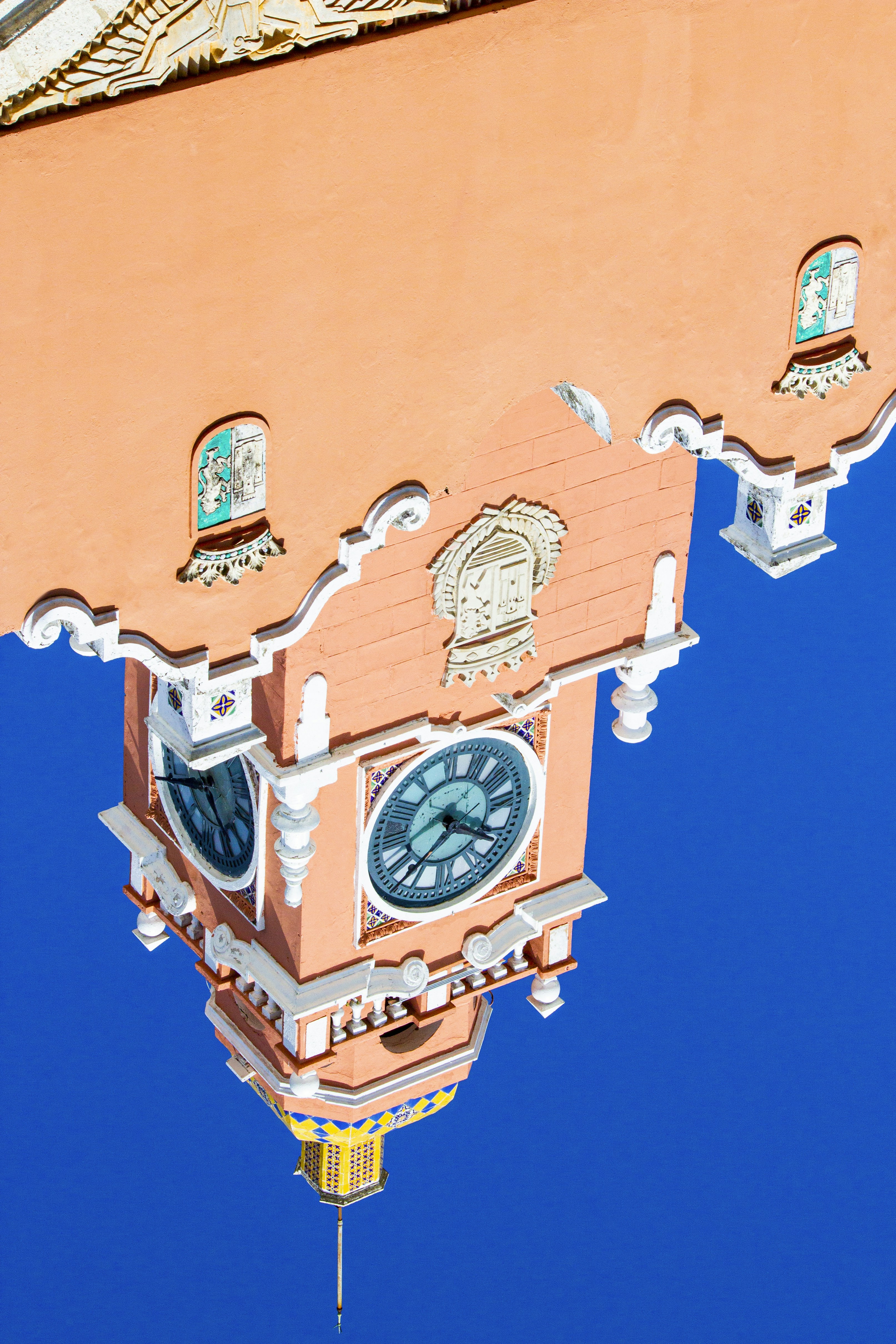 a reflection of a clock tower in the water