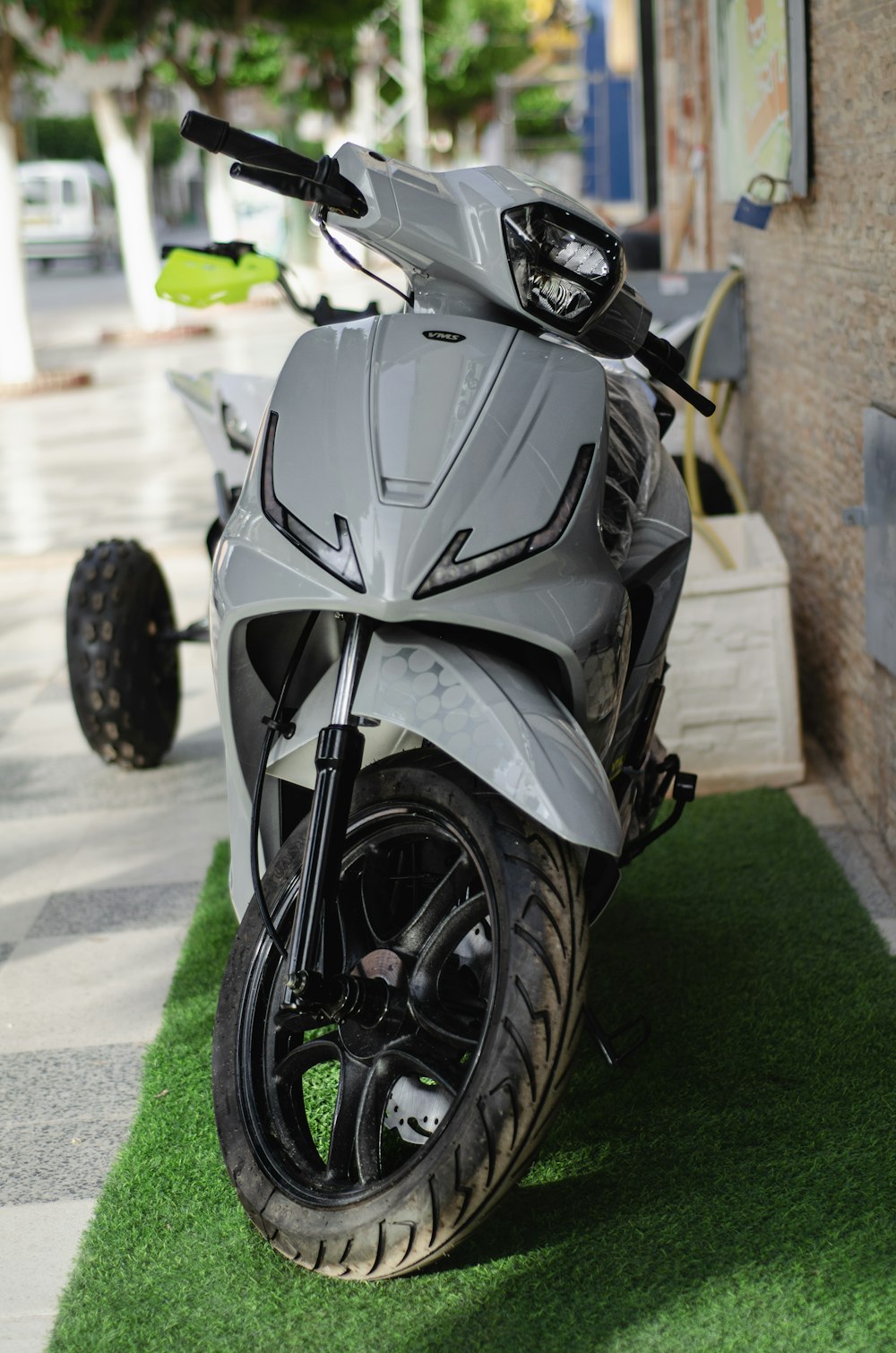 a motorcycle is parked on the grass near a building