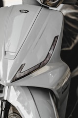 A close-up of a scooter's sleek design features.
