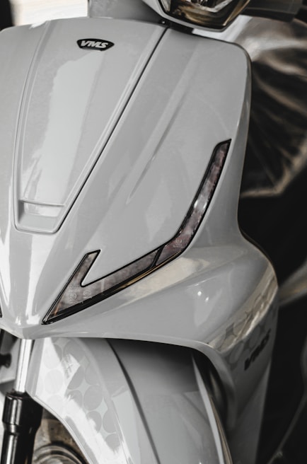 Close-up of a lightweight electric scooter with a glossy finish and digital display