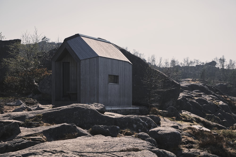 a small building sitting on top of a rocky hillside