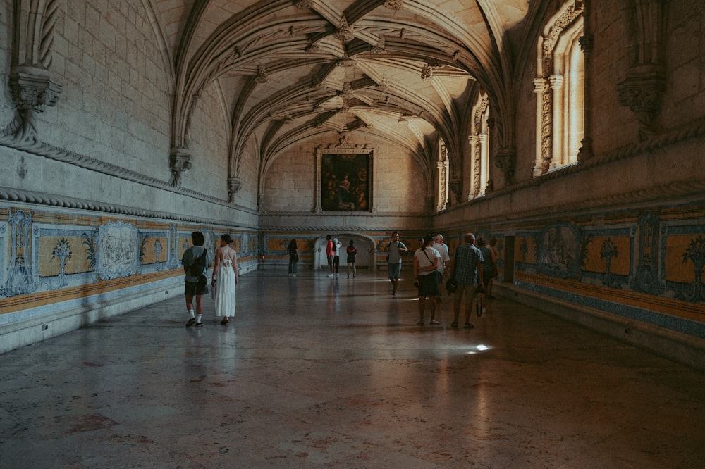 a group of people standing in a large building