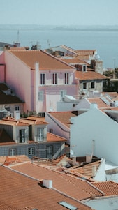 A scenic view of a coastal town with vibrant buildings and a clear blue sky.