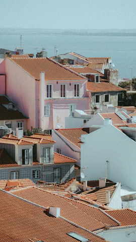 A scenic shot of a coastal town in Spain with colorful houses and bright sunlight.