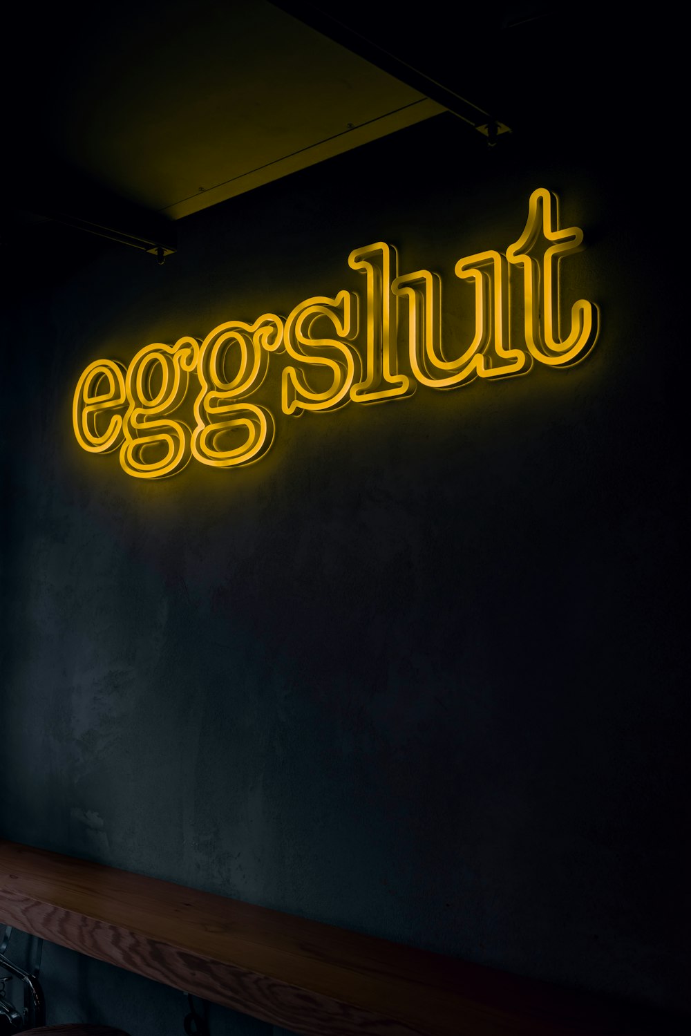 a neon sign on the wall of a restaurant