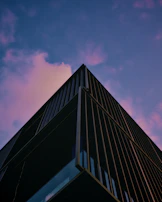 A sleek real estate exterior at twilight, highlighting architectural lines against a charcoal sky.