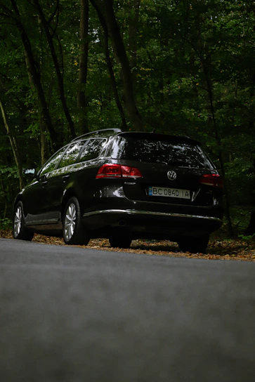 A sleek new Volkswagen Passat with Ardi Rental license plate parked by the seaside in Golem.
