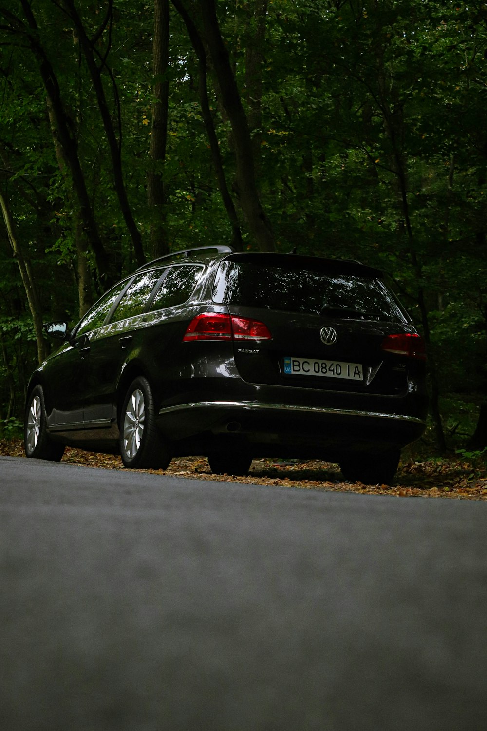 a black car parked on the side of the road