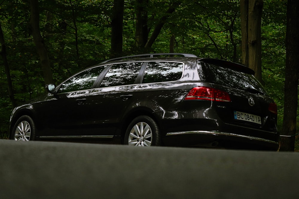 a black car parked on the side of the road