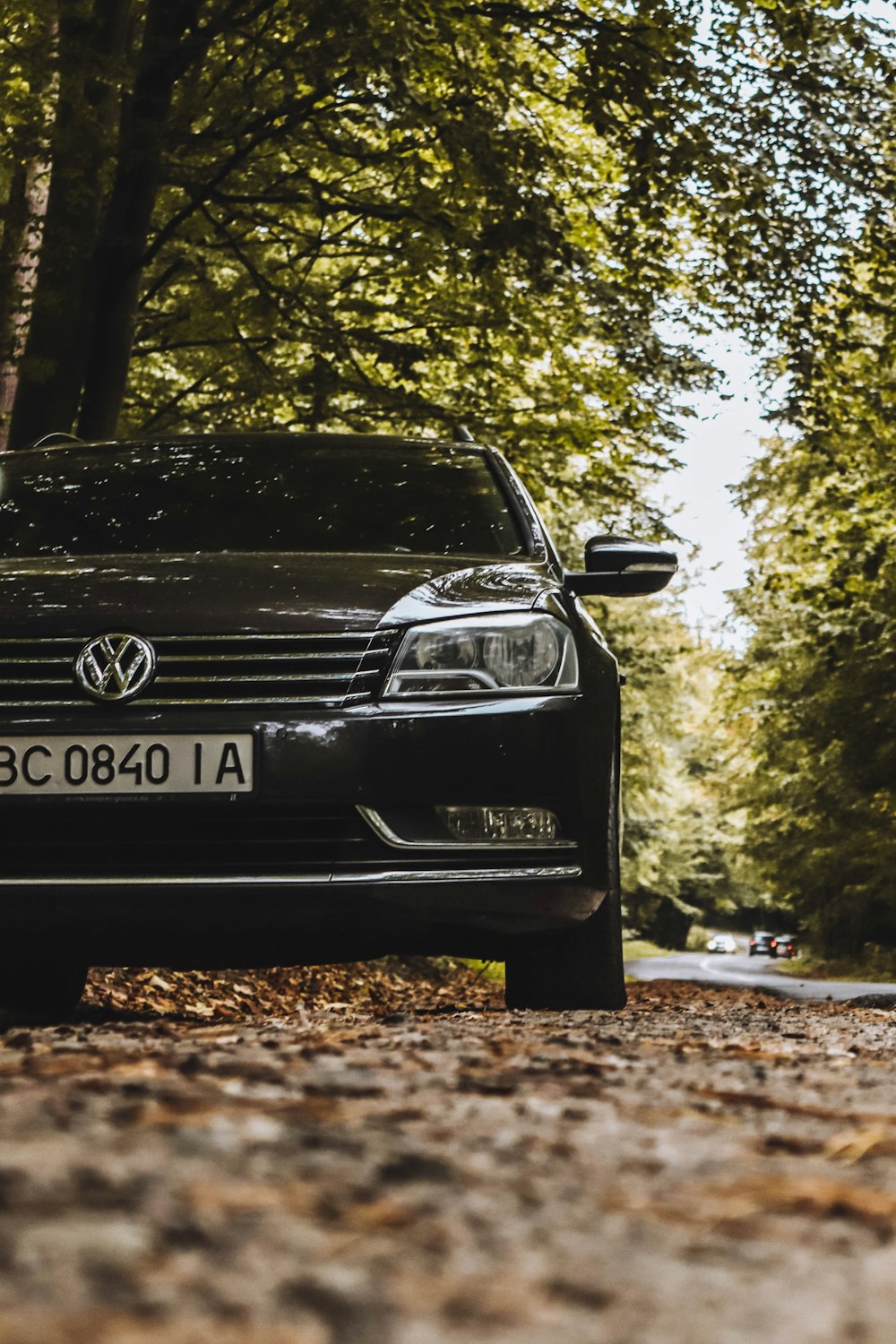 a black car parked on the side of a road