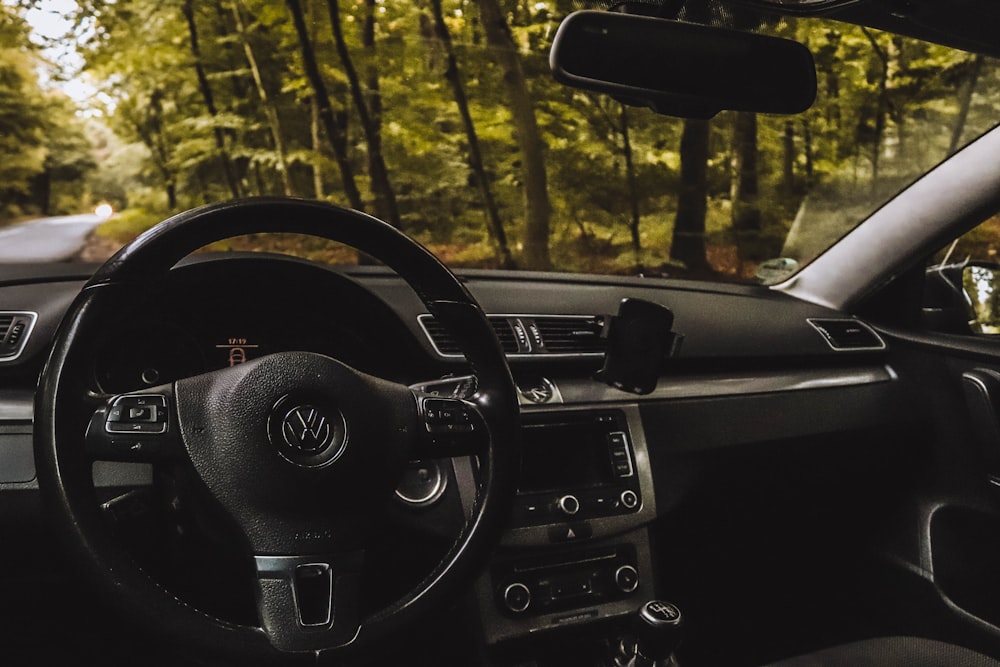 the interior of a car with a steering wheel and dashboard