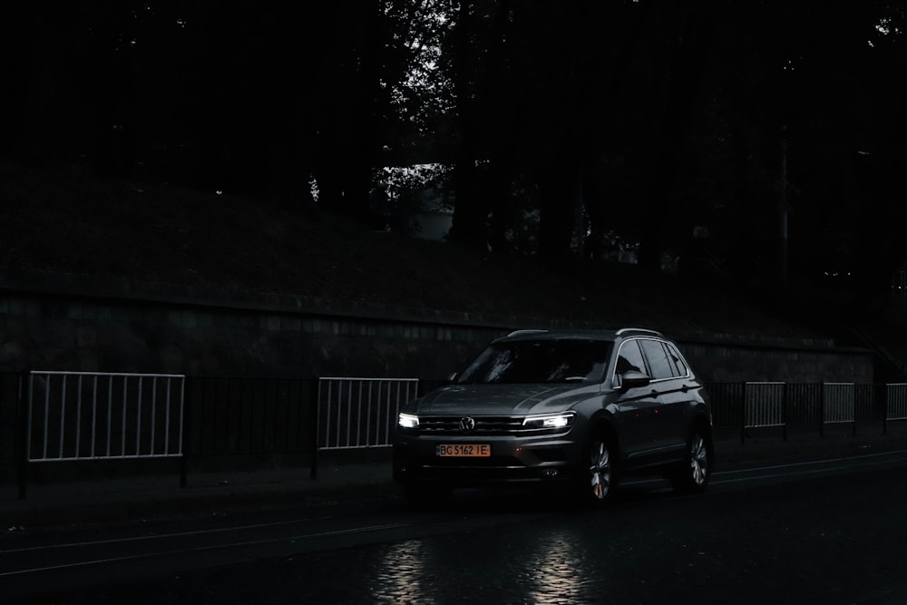 a car driving down a street at night