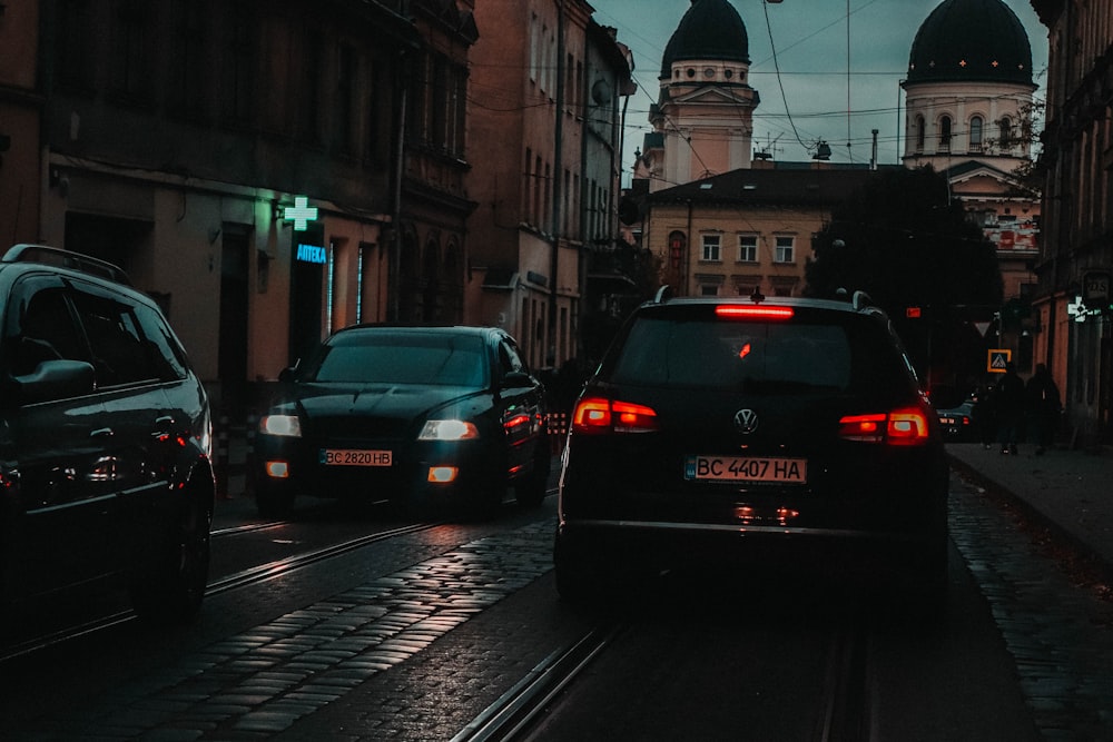 a couple of cars that are sitting in the street