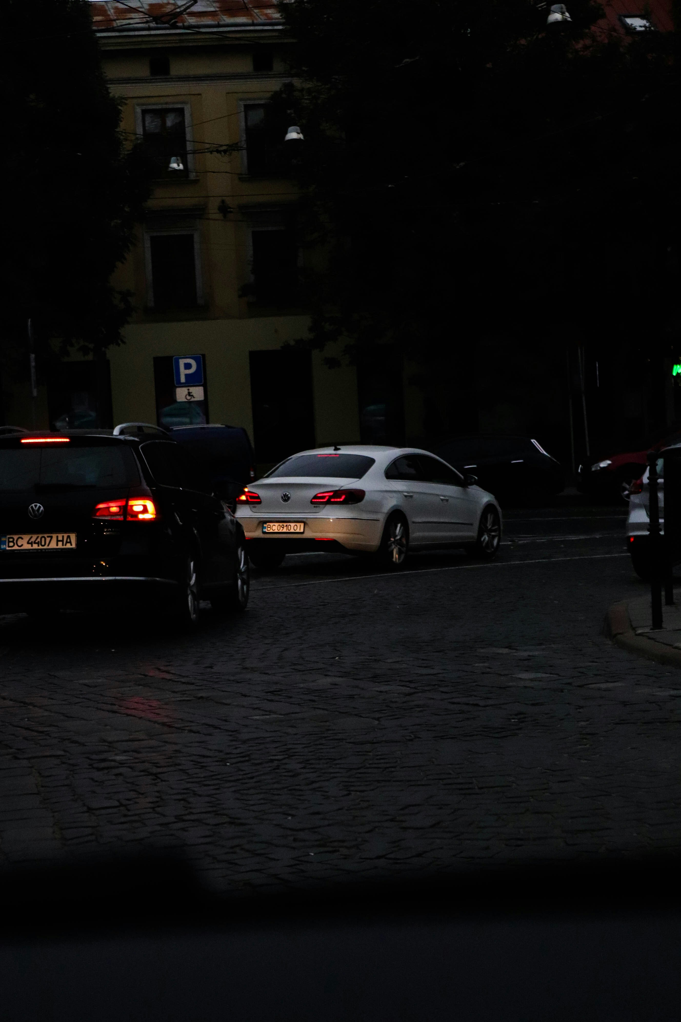 a couple of cars that are sitting in the street