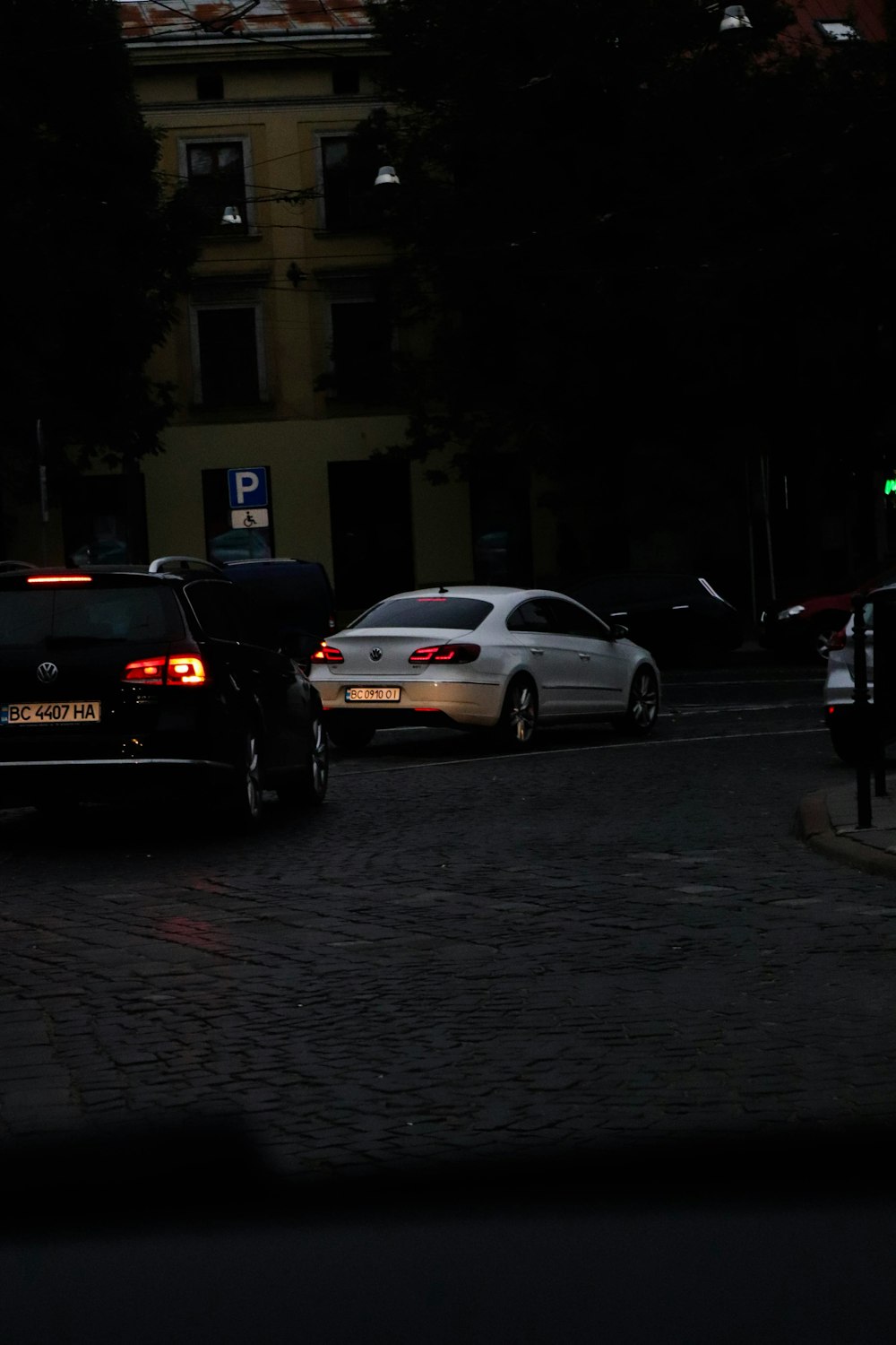 a couple of cars that are sitting in the street