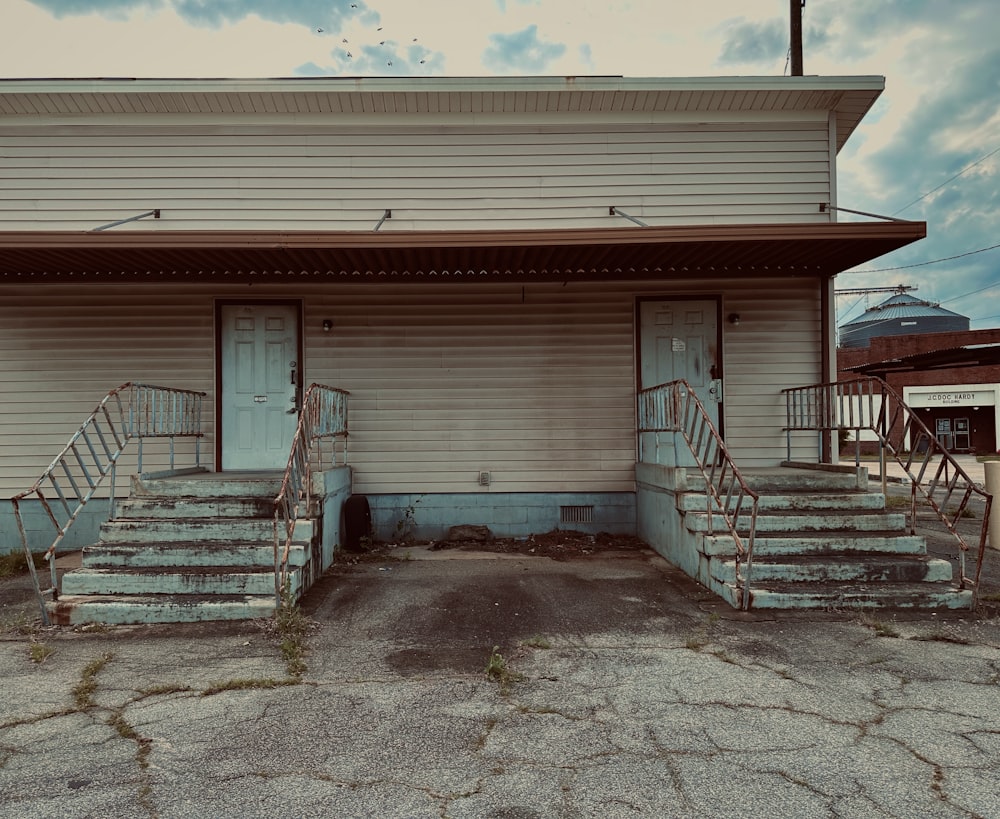 a run down building with stairs leading up to it