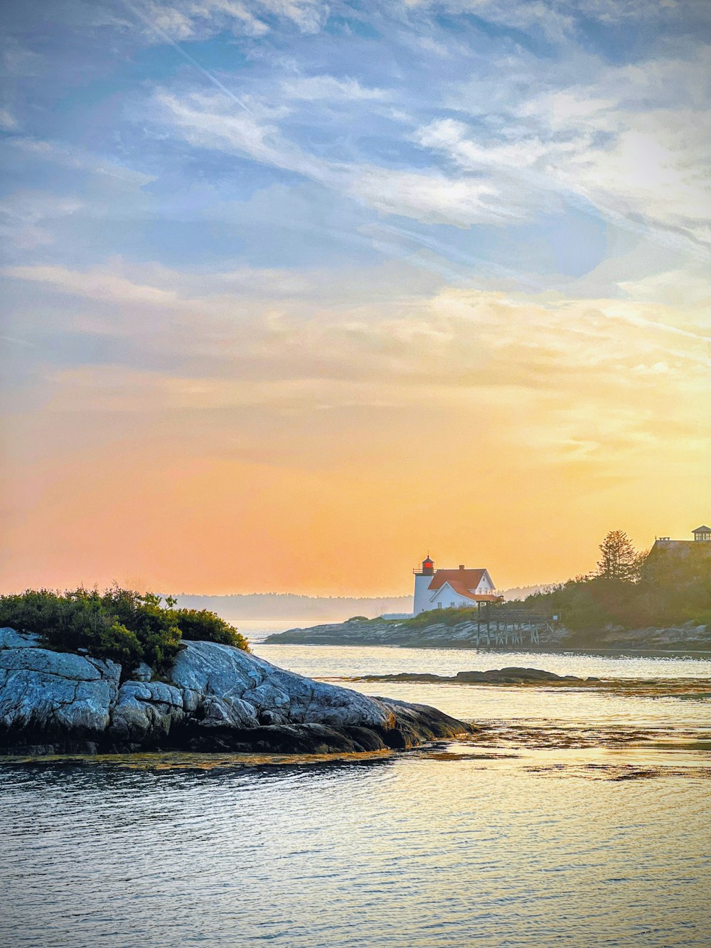 a lighthouse on a small island in the middle of a body of water