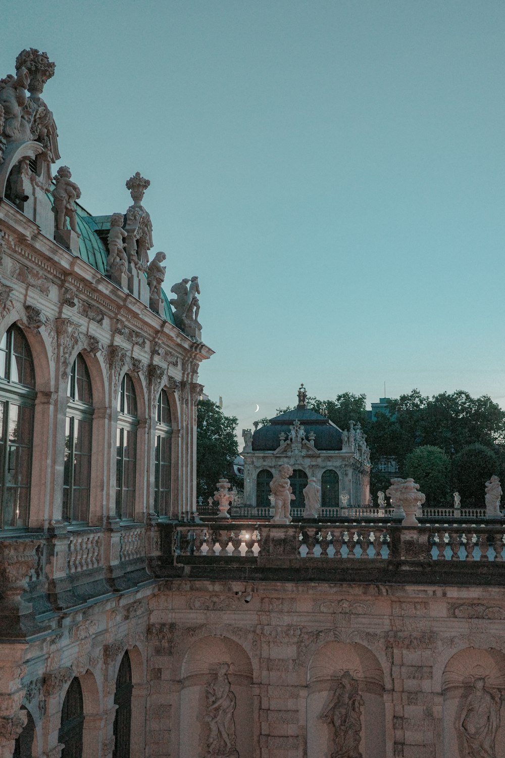 a large building with statues on the top of it