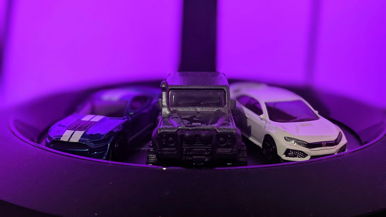 Group of die-cast toy cars parked together on a table, an illustrative real photo of the miniature-car world behind the Matchbox toy line, with no people in the frame