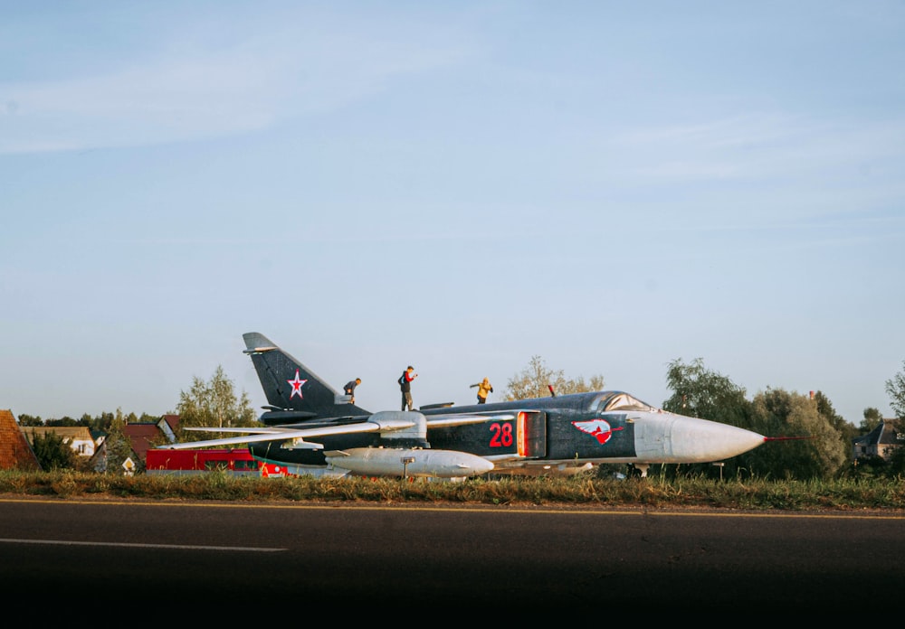 a fighter jet sitting on top of an airport runway