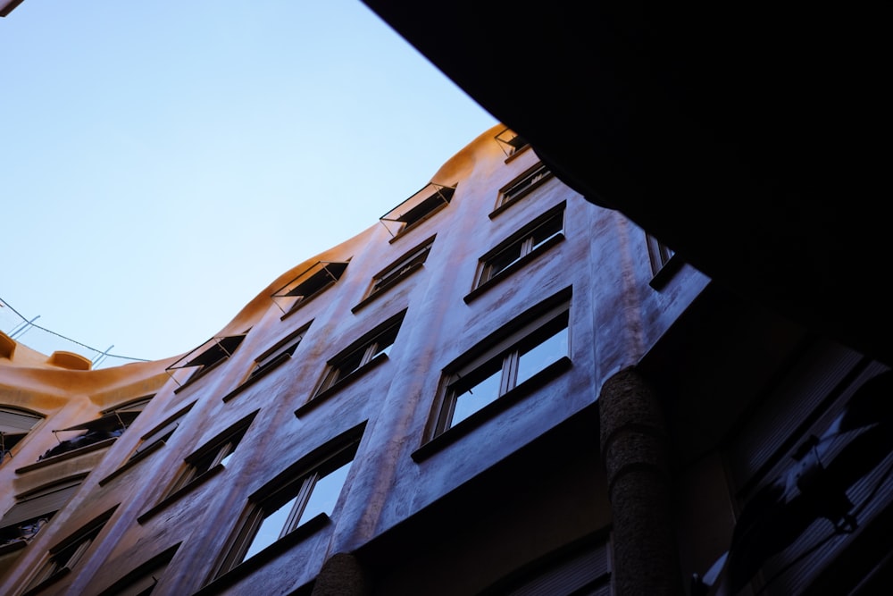 looking up at a tall building with windows