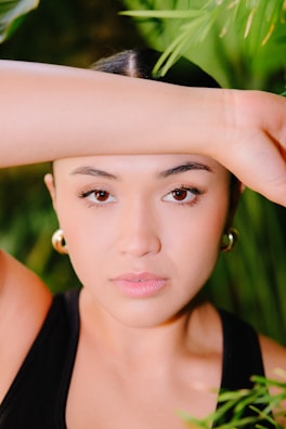 a woman is posing for a picture with her hand on her head