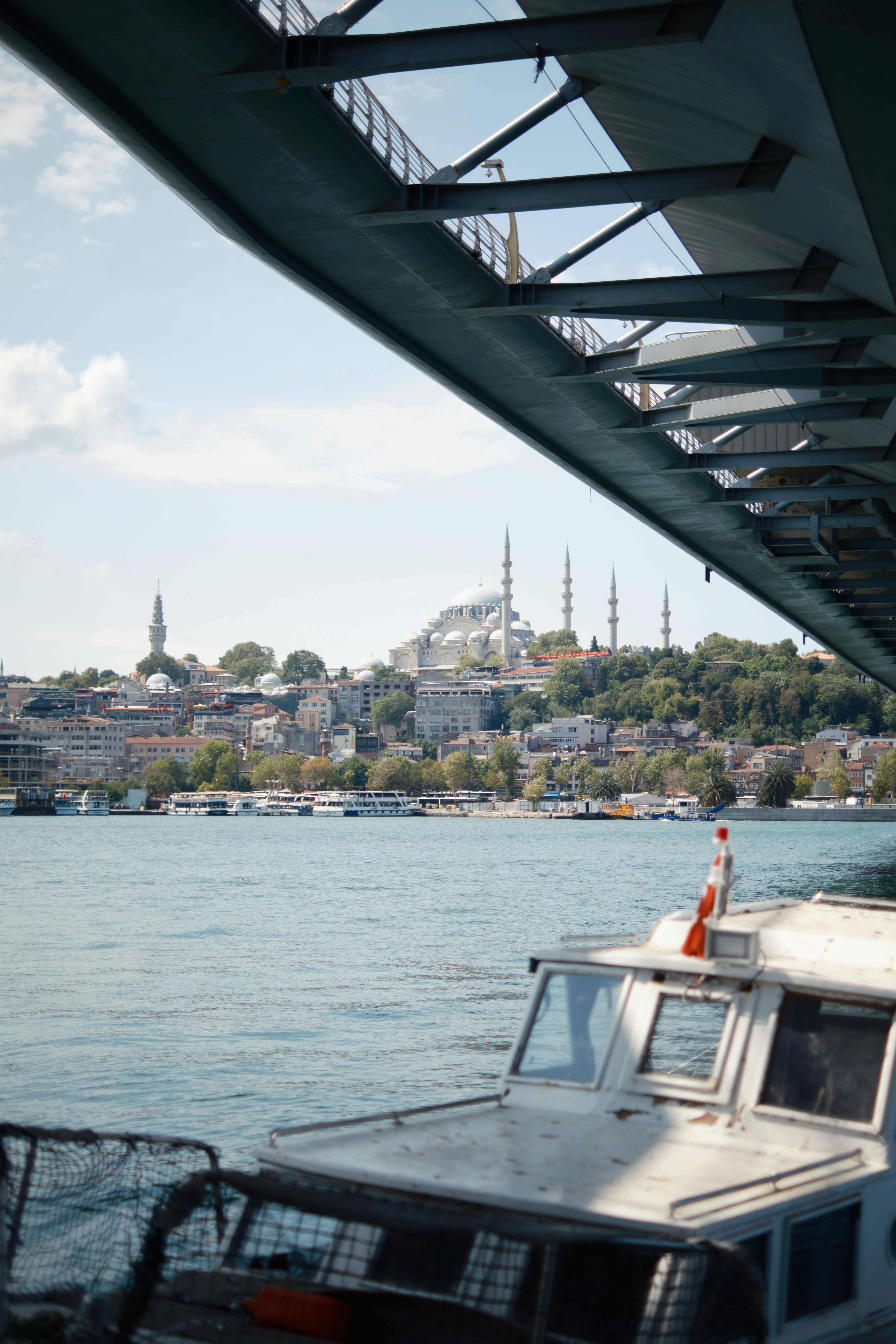 A boat is sitting in the water under a bridge photo – Free Istanbul ...