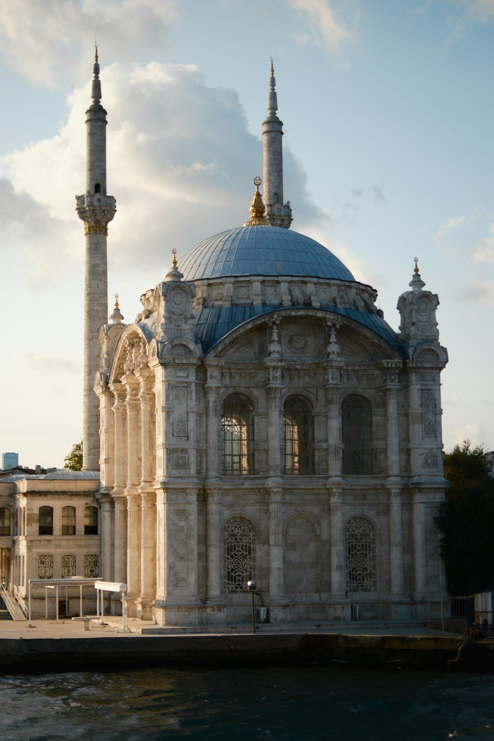 a large building with a blue dome on top of a body of water