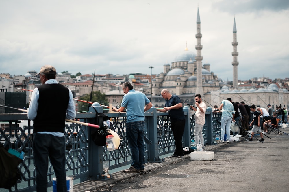 a group of people standing on top of a bridge