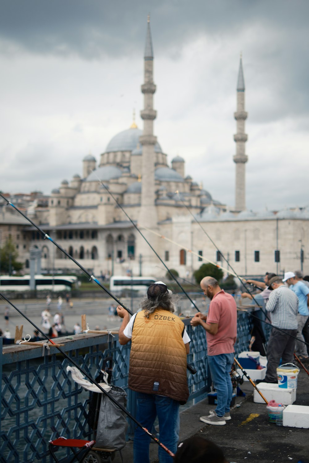 a group of people fishing on a bridge