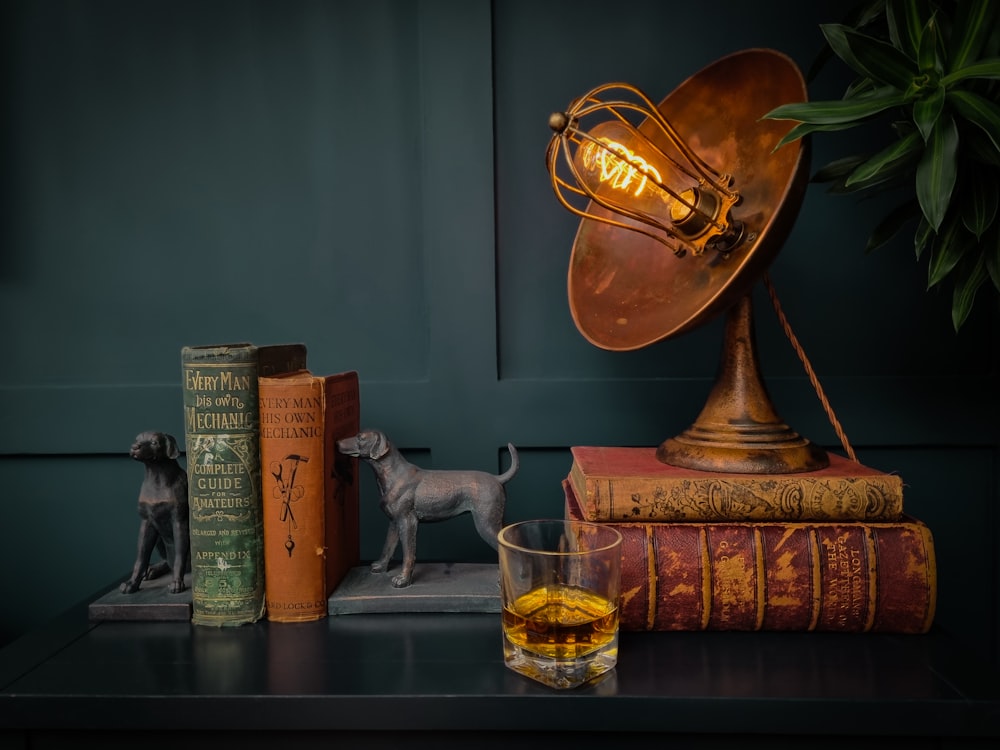 a table topped with books and a lamp