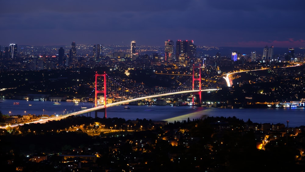 a view of a city and a bridge at night