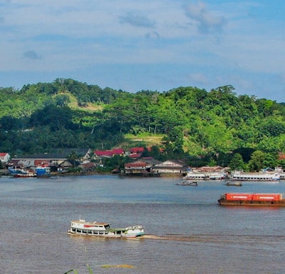 a river filled with lots of boats floating on top of it