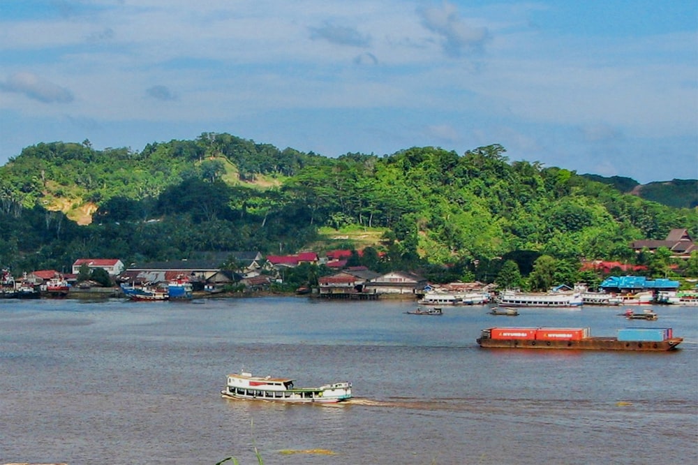 a river filled with lots of boats floating on top of it