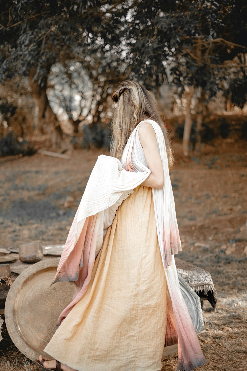 a woman in a long dress standing in a field