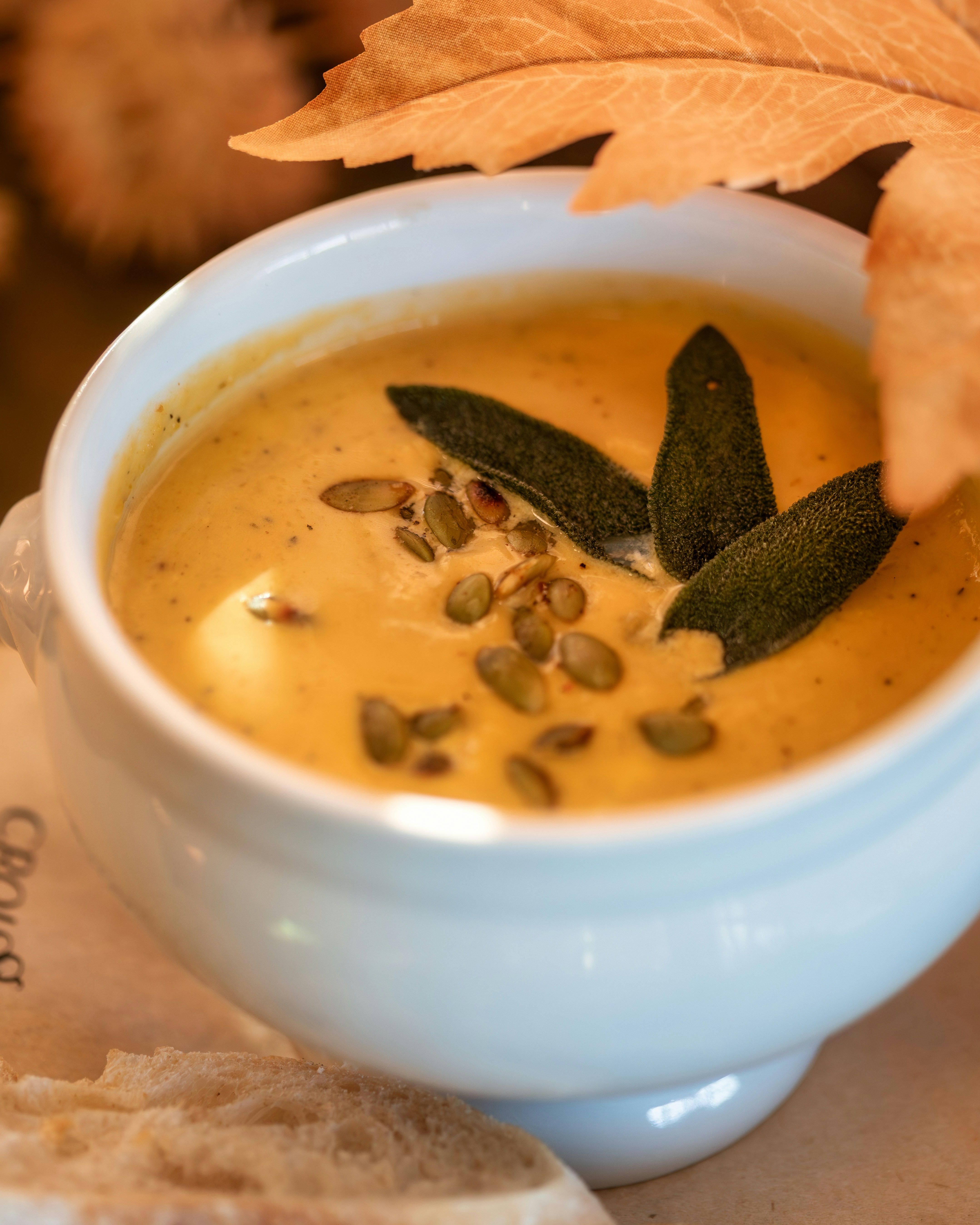 a bowl of soup with a leaf on top of it