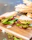 Happy customer biting into an avocado sandwich inside pepechop