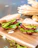 Happy customer biting into an avocado sandwich inside pepechop