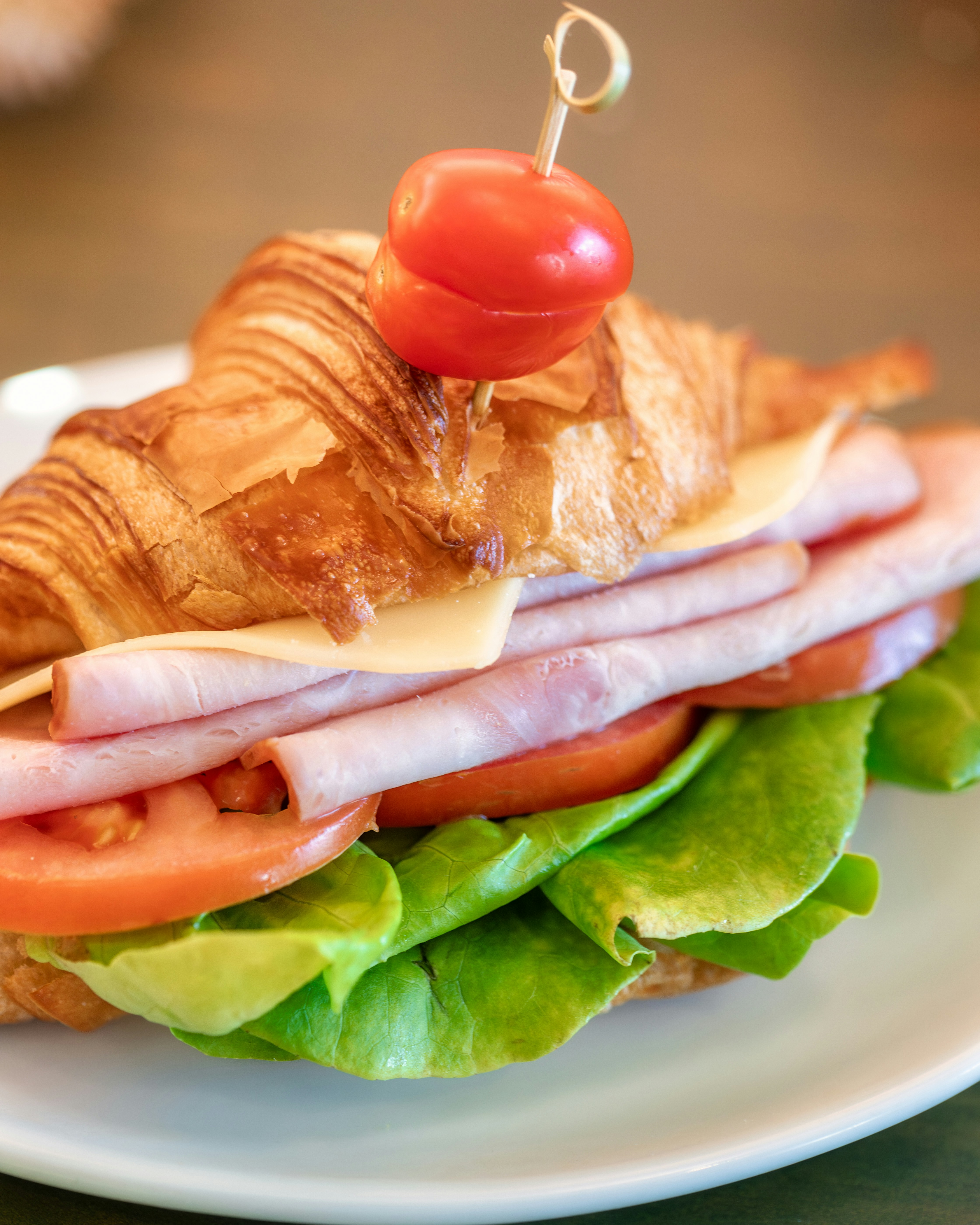 ein Sandwich mit Fleisch, Käse, Tomaten und Salat