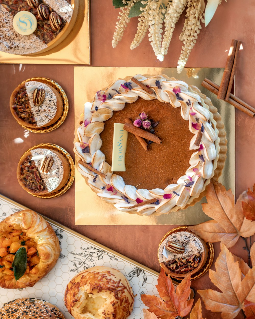 a table topped with lots of different types of pies