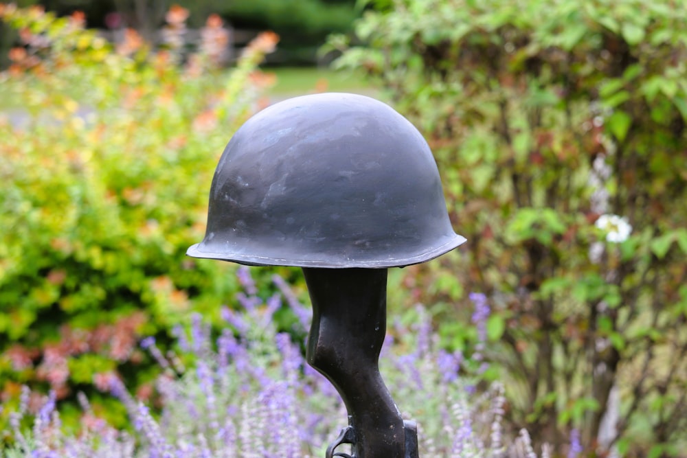 a close up of a helmet on top of a statue