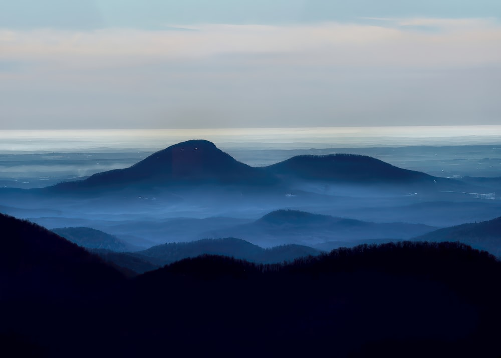 a view of a mountain range covered in fog