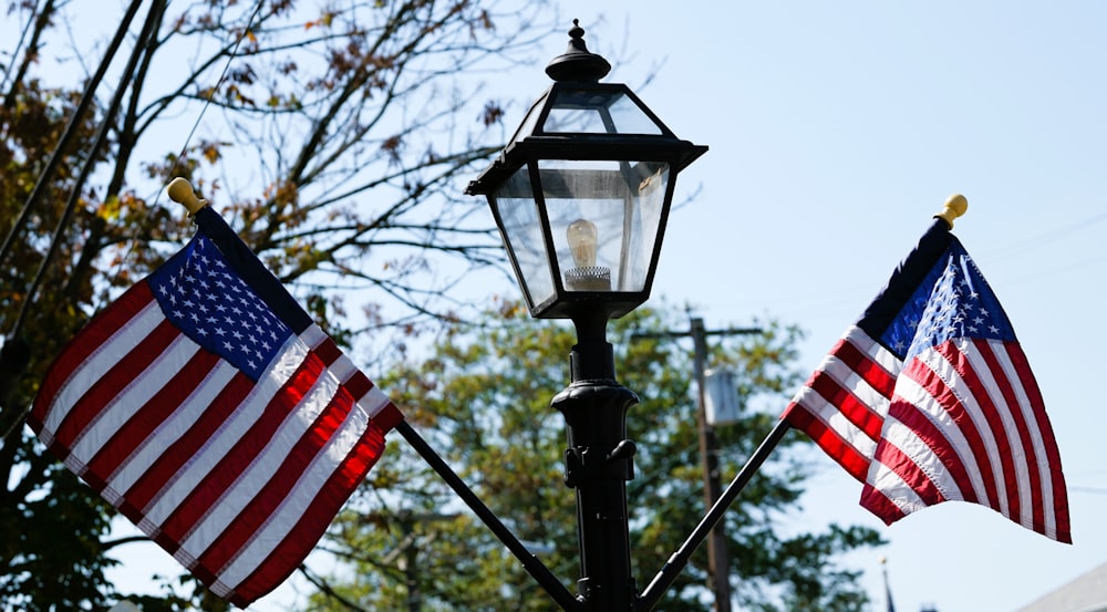 a lamp post with two american flags on it