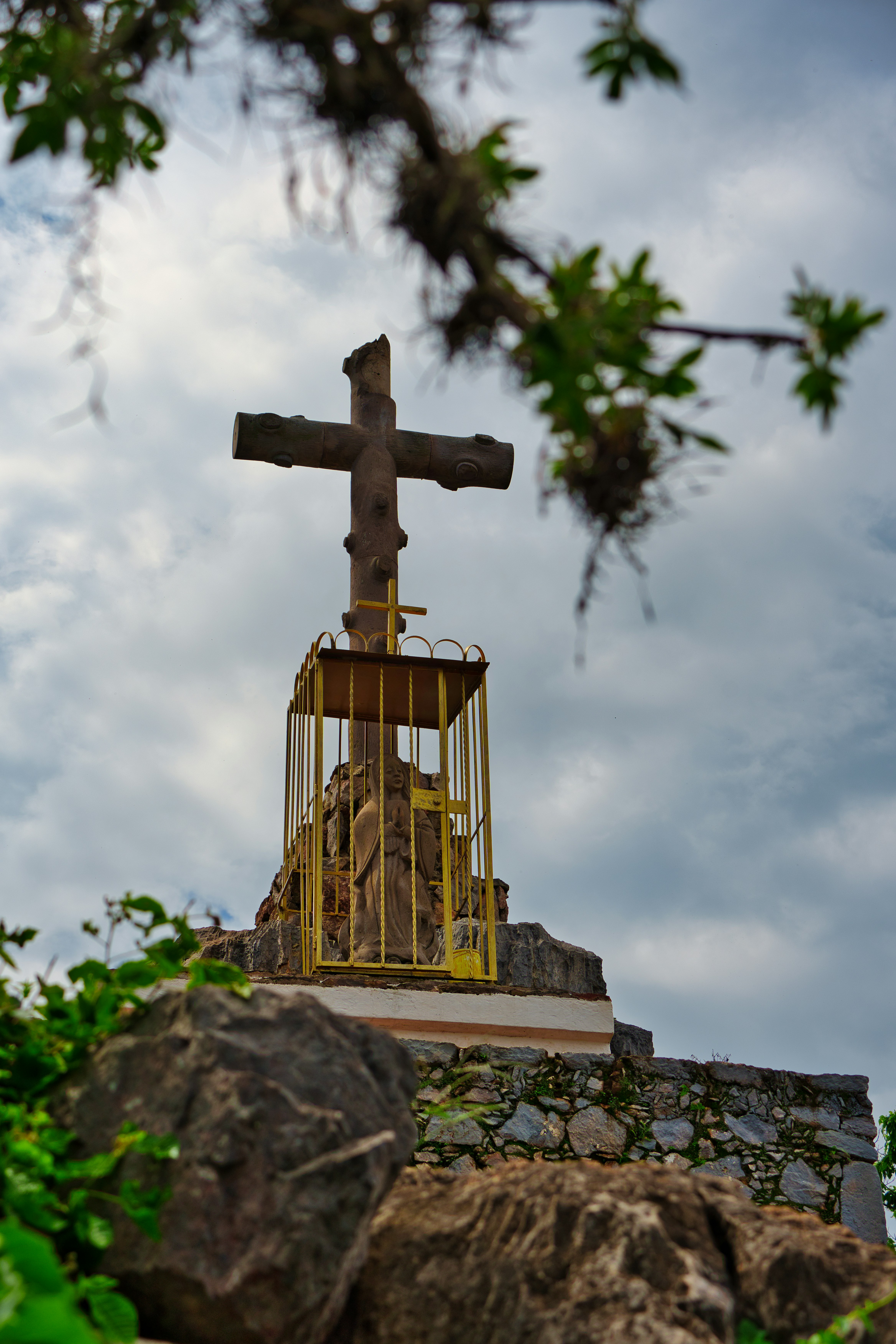 a cross on top of a building with a birdcage