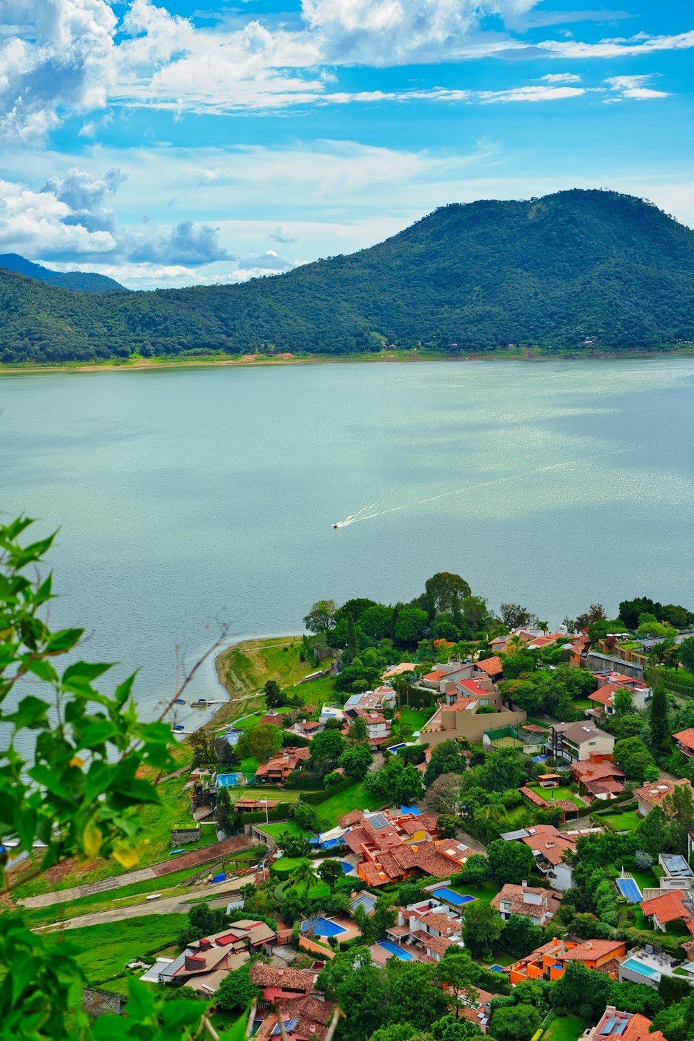 an aerial view of a small town by a large body of water