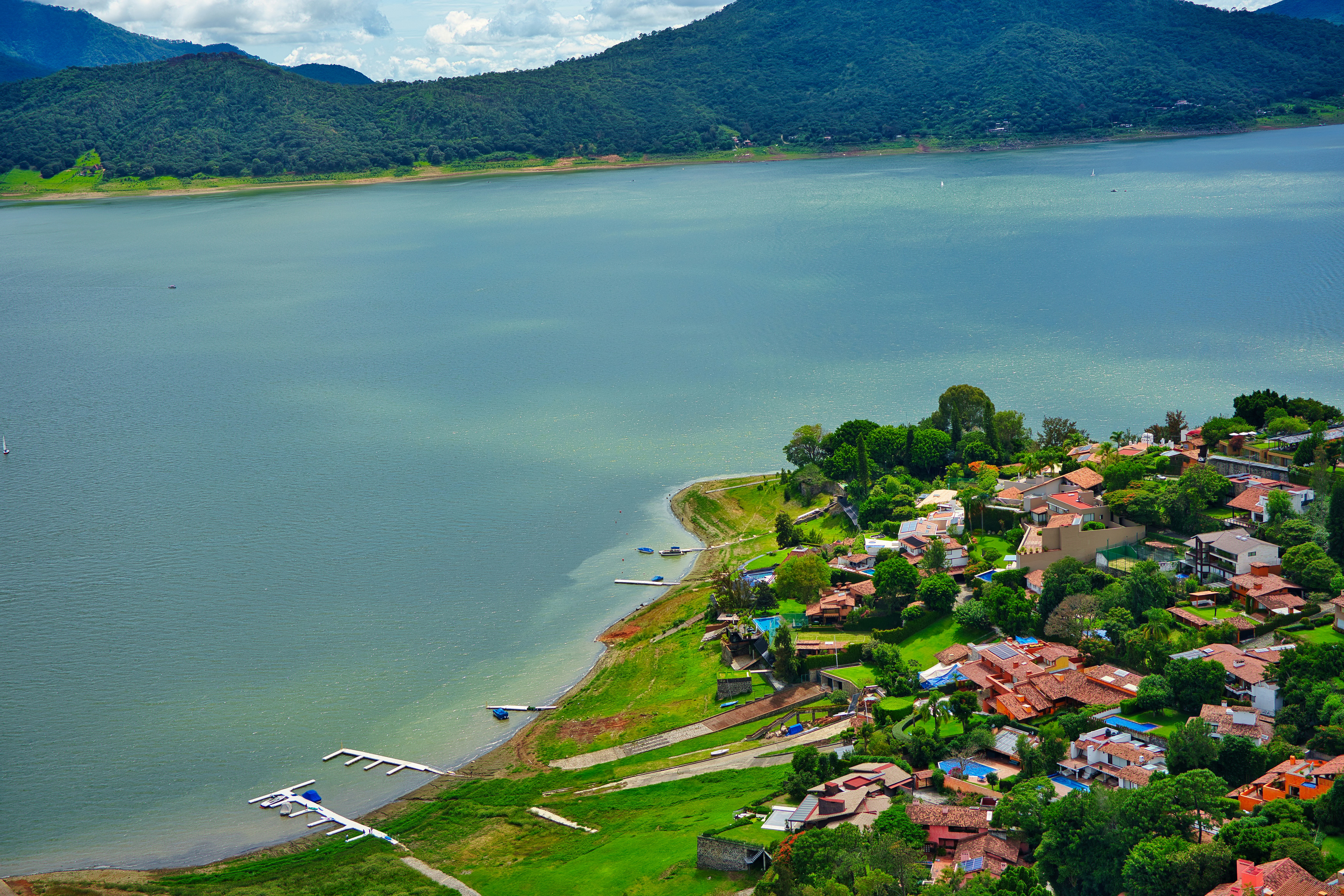 an aerial view of a small village by a lake