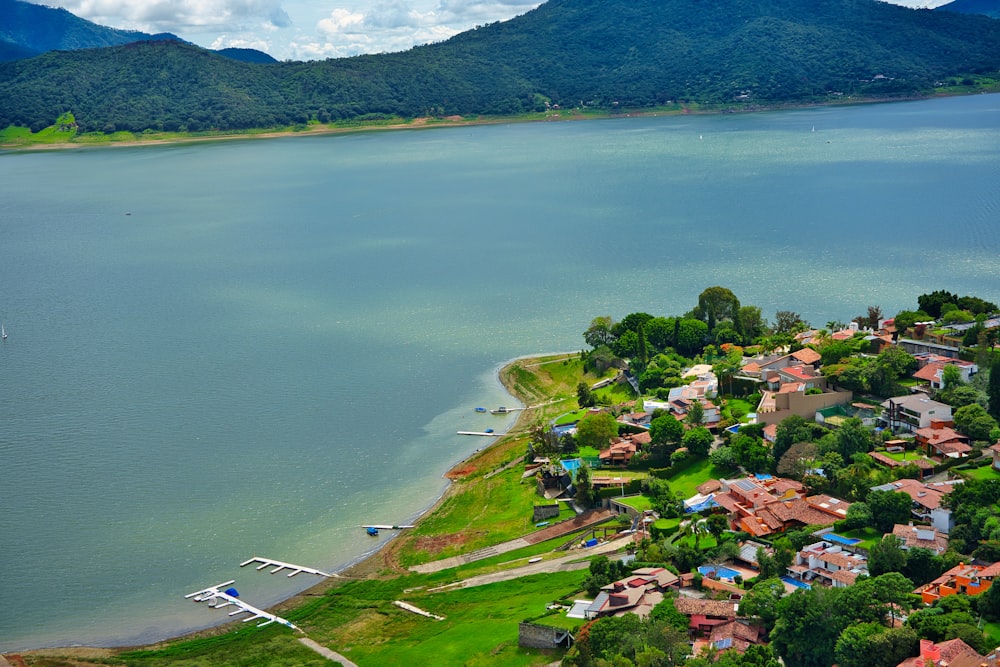 an aerial view of a small village by a lake