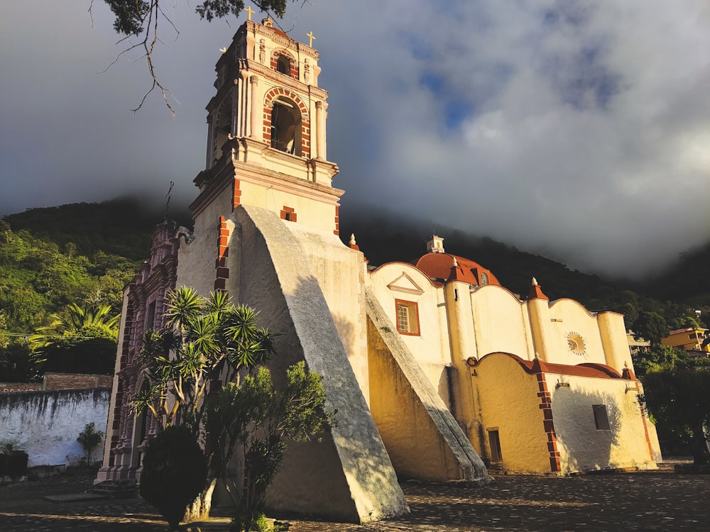 a church with a steeple and a bell tower