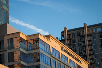 High-resolution drone photograph of a modern medical practice building under soft twilight.