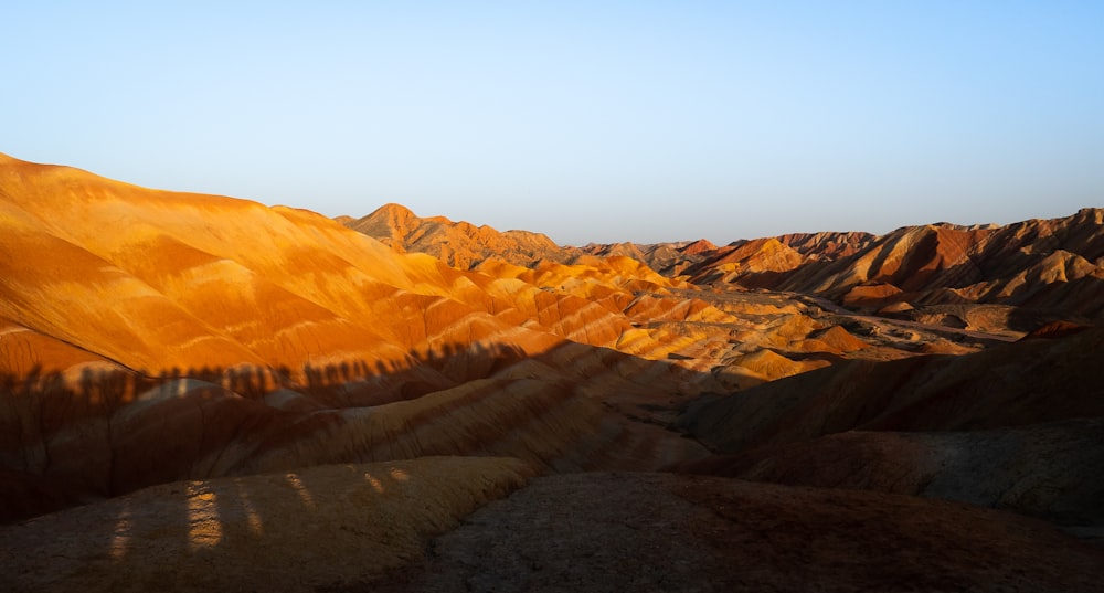 a view of a mountain range with a blue sky in the background